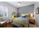 Bright bedroom with a yellow bed frame, gray accent wall, and shuttered window at 8803 18Th Nw Ave, Bradenton, FL 34209