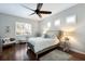 Relaxing bedroom with dark wood floors, a ceiling fan, and bright natural light at 8803 18Th Nw Ave, Bradenton, FL 34209