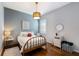 Inviting bedroom with wood floors, shiplap accent wall and neutral decor at 8803 18Th Nw Ave, Bradenton, FL 34209