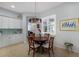 Cozy dining area with a modern chandelier and plantation shutters allowing ample natural light at 8803 18Th Nw Ave, Bradenton, FL 34209