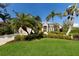 Well-manicured lawn and mature palm trees accentuate the facade of this appealing single story home at 8803 18Th Nw Ave, Bradenton, FL 34209