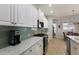 Elegant kitchen with granite countertops, stainless steel appliances, and a stylish tile backsplash at 8803 18Th Nw Ave, Bradenton, FL 34209