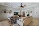 Bright living room with tray ceilings, a ceiling fan, and an entertainment area with a large flat-screen TV at 8803 18Th Nw Ave, Bradenton, FL 34209