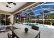 Screened-in patio with dining set offering views of the pool and backyard, creating an ideal outdoor retreat at 8803 18Th Nw Ave, Bradenton, FL 34209