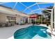 Screened-in pool area with an in-ground pool and an umbrella table and seating at 8803 18Th Nw Ave, Bradenton, FL 34209
