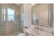 Bright bathroom with glass-enclosed shower, toilet and single vanity with marble countertop at 1111 Mallorca Dr, Bradenton, FL 34209