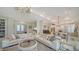 Bright, open-concept living room with a large sectional sofa and chandelier at 1111 Mallorca Dr, Bradenton, FL 34209