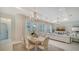 Bright living room and dining area with neutral tones, elegant chandeliers and lots of natural light at 1111 Mallorca Dr, Bradenton, FL 34209