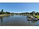 Scenic waterfront view with boats docked along the canal in a lush, tropical setting under a clear blue sky at 1111 Mallorca Dr, Bradenton, FL 34209