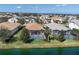 Aerial view of backyard with screened in pool overlooking a tranquil pond at 12326 Blue Hill Trl, Bradenton, FL 34211