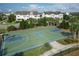 View of community basketball court with well-maintained court and basketball hoops surrounded by neighborhood homes at 12326 Blue Hill Trl, Bradenton, FL 34211
