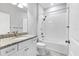 Modern bathroom with a tiled shower-tub combination, granite countertop, and updated fixtures at 12326 Blue Hill Trl, Bradenton, FL 34211