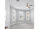Bright bedroom featuring neutral walls, carpet flooring, and three windows with shutter blinds at 12326 Blue Hill Trl, Bradenton, FL 34211