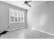 Bedroom with tile flooring, neutral gray paint, and white shutter blinds at 12326 Blue Hill Trl, Bradenton, FL 34211