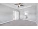 Spacious bedroom featuring a tray ceiling and access to the ensuite bathroom at 12326 Blue Hill Trl, Bradenton, FL 34211