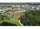 Aerial view of community playground, basketball court, pool, dog park, walking path, and lake at 12326 Blue Hill Trl, Bradenton, FL 34211