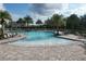 Inviting community pool with a shallow entry, fountains, and palm trees at 12326 Blue Hill Trl, Bradenton, FL 34211