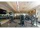 Spacious fitness center features modern weight training and cardio equipment with large windows and ceiling fans at 12326 Blue Hill Trl, Bradenton, FL 34211