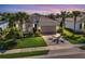 Beautiful single-Gathering home featuring a tile roof, palm trees, and a well-manicured front lawn at 12326 Blue Hill Trl, Bradenton, FL 34211