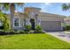 Well-maintained single-Gathering home with lush landscaping and a brick driveway in a suburban setting at 12326 Blue Hill Trl, Bradenton, FL 34211