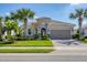Attractive home with a tile roof, tidy landscaping, and a brick driveway leading to the garage at 12326 Blue Hill Trl, Bradenton, FL 34211