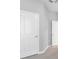 Hallway with two paneled doors, neutral paint and carpet at 12326 Blue Hill Trl, Bradenton, FL 34211