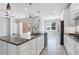 Bright kitchen featuring a large granite island, stainless steel appliances, and pendant lighting at 12326 Blue Hill Trl, Bradenton, FL 34211