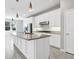Spacious kitchen with granite countertops, a large island, stainless steel appliances, and white cabinetry at 12326 Blue Hill Trl, Bradenton, FL 34211