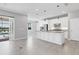 Modern kitchen with a large island, stainless steel appliances and lake view at 12326 Blue Hill Trl, Bradenton, FL 34211