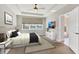 Bright primary bedroom with large window overlooking a scenic view and tray ceiling with fan at 12326 Blue Hill Trl, Bradenton, FL 34211