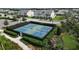 Community pickleball courts surrounded by lush landscaping, homes, and sidewalk at 12326 Blue Hill Trl, Bradenton, FL 34211