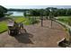 View of playground with climbing equipment, swing sets and slides, surrounded by woodchips at 12326 Blue Hill Trl, Bradenton, FL 34211