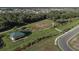 Overhead view of a community park featuring a covered picnic area, playground, lush landscaping, and walking paths at 12326 Blue Hill Trl, Bradenton, FL 34211