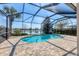 A private screened-in pool overlooks a tranquil lake at 12326 Blue Hill Trl, Bradenton, FL 34211