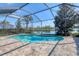 Gorgeous screened-in pool area with brick pavers and relaxing waterfront views at 12326 Blue Hill Trl, Bradenton, FL 34211