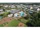 Aerial view of community pool, tennis court, and playground with slides and climbing equipment at 12326 Blue Hill Trl, Bradenton, FL 34211