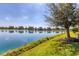 Picturesque lakefront property with a clear reflection of the sky and trees at 12326 Blue Hill Trl, Bradenton, FL 34211