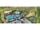 Aerial view of a community pool, playground, and sand volleyball court at 12716 Dusty Trail Dr, Sarasota, FL 34238