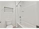 White tiled bathroom with shower and toilet at 12716 Dusty Trail Dr, Sarasota, FL 34238