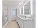 Stylish bathroom with double vanity, glass shower, and modern fixtures at 12716 Dusty Trail Dr, Sarasota, FL 34238