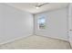 Neutral bedroom with window, carpeted floor, and ceiling fan at 12716 Dusty Trail Dr, Sarasota, FL 34238