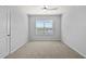 Clean empty bedroom with a ceiling fan and a large window at 12716 Dusty Trail Dr, Sarasota, FL 34238