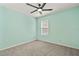 This bedroom has a gray carpet, a window, and a ceiling fan at 12716 Dusty Trail Dr, Sarasota, FL 34238