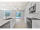 Modern kitchen with an island, stainless steel appliances, and a view of the pool at 12716 Dusty Trail Dr, Sarasota, FL 34238