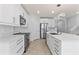 Bright kitchen features white cabinetry, stainless steel appliances, and a large island at 12716 Dusty Trail Dr, Sarasota, FL 34238