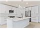 Bright kitchen features white cabinets, stainless steel appliances and an island at 12716 Dusty Trail Dr, Sarasota, FL 34238