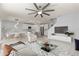 Open-concept living room with kitchen, modern decor, and ample natural light at 12716 Dusty Trail Dr, Sarasota, FL 34238