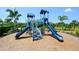 Community playground featuring a blue playset with slides and climbing features at 12716 Dusty Trail Dr, Sarasota, FL 34238
