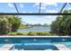 Relaxing backyard pool with spa featuring water features and pond view at 12716 Dusty Trail Dr, Sarasota, FL 34238