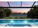 Relaxing backyard pool with spa featuring water features and pond view at sunset at 12716 Dusty Trail Dr, Sarasota, FL 34238